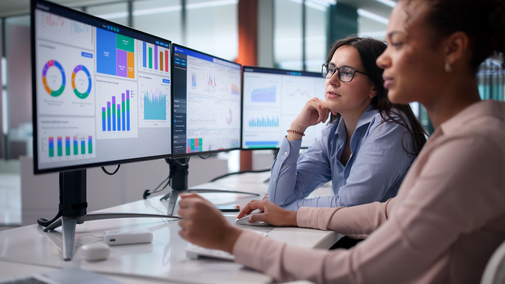 Marketing manager reviewing campaign analytics on laptop in co-working space